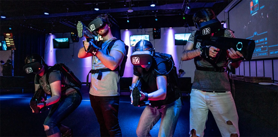 Four individuals in VR gear enjoying an experience at Battleground in LA.