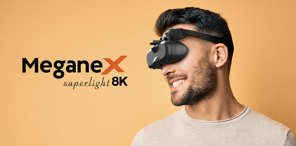 Smiling man wearing the MeganeX Superlight 8K VR Headset